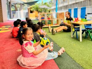 Educator children outside play | Easing the Transition: Helping Your Child Adapt to Early Childhood Education and Care